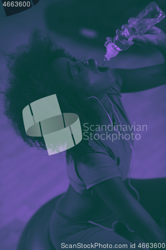 Image of young afro american woman in gym have pilates workout break