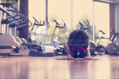 Image of african american woman exercise yoga in gym