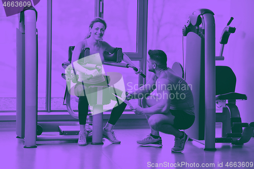 Image of woman exercising with her personal trainer