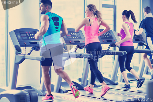 Image of Group of people running on treadmills