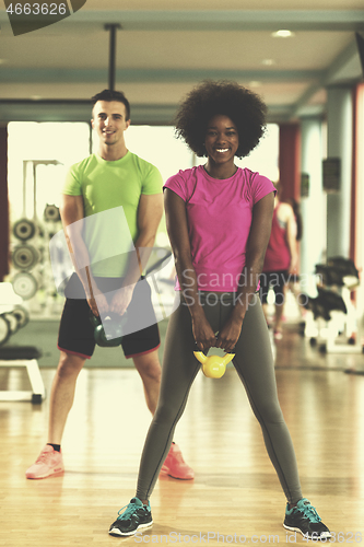 Image of couple  workout with weights at  crossfit gym