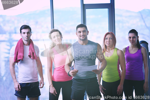 Image of Group of people exercising at the gym