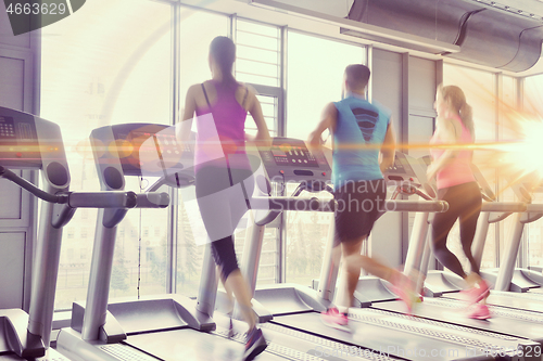 Image of Group of people running on treadmills