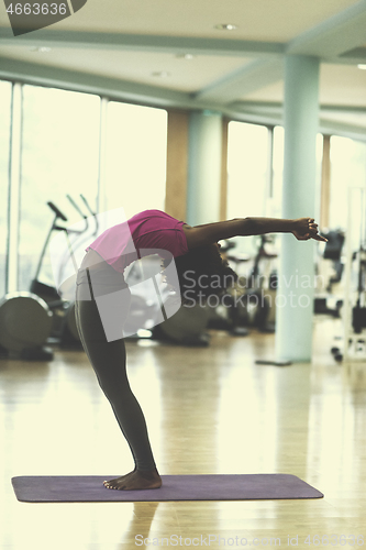 Image of african american woman exercise yoga in gym