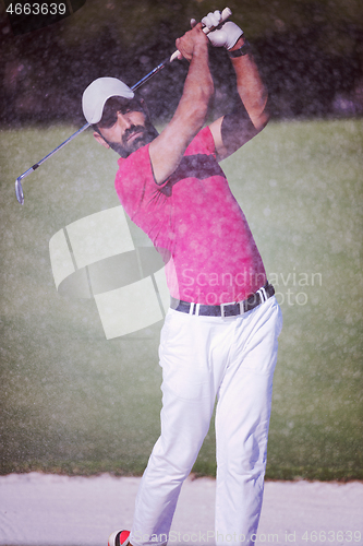 Image of golfer hitting a sand bunker shot