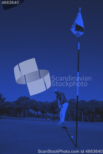 Image of golf player hitting shot at sunny day