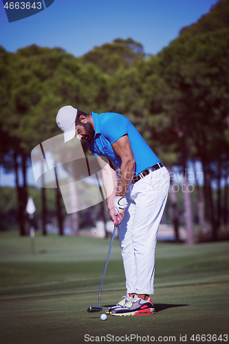 Image of golf player hitting shot at sunny day