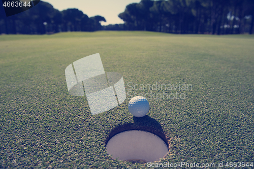 Image of golf ball in the hole