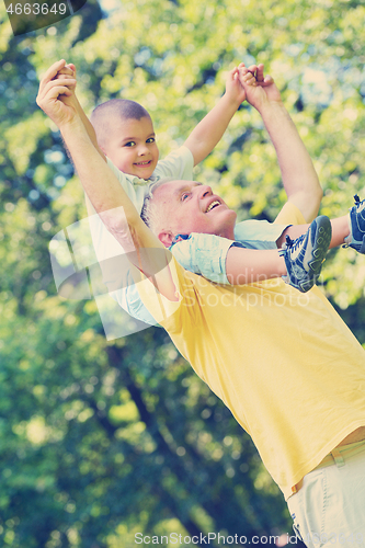 Image of happy grandfather and child in park