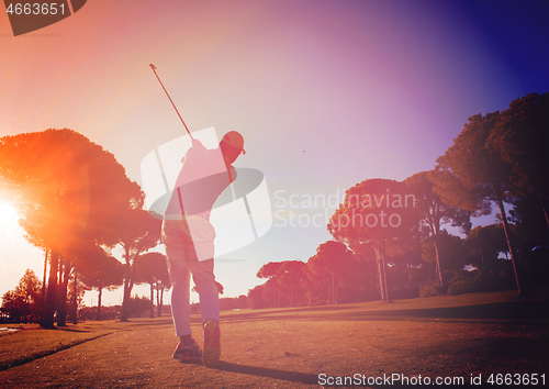 Image of golf player hitting shot with club