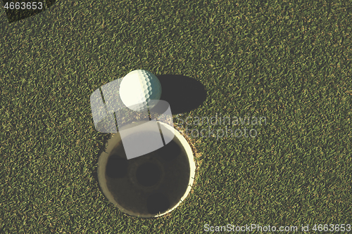 Image of top view of golf ball in the hole