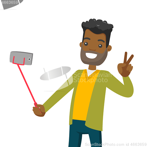 Image of A black man making selfie on his cellphone with a selfie stick.