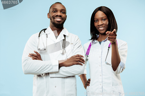 Image of The female and male happy afro american doctors on blue background