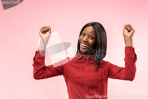 Image of Winning success woman happy ecstatic celebrating being a winner. Dynamic energetic image of female afro model