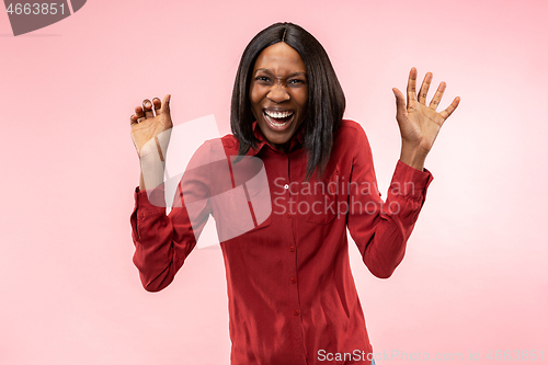 Image of The happy african woman standing and smiling against red background.
