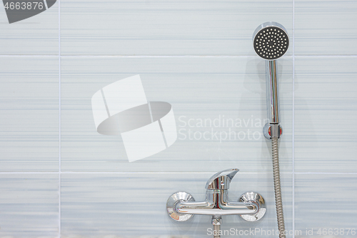 Image of Blue tiled shower mixer and shower head