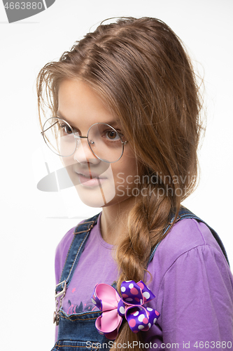 Image of Portrait of a girl in round glasses with an interesting and distracted look