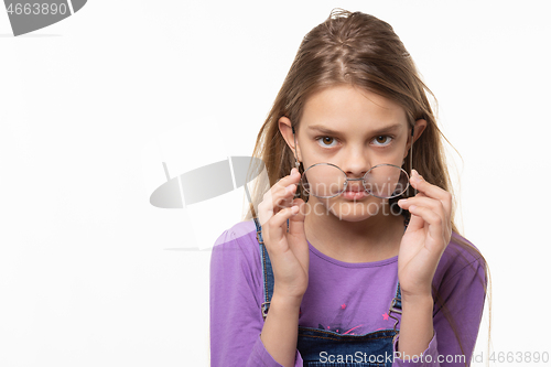 Image of Teen girl takes off glasses isolated on white background