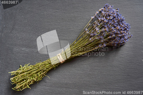 Image of A bunch of lavender flowers on on stone surface