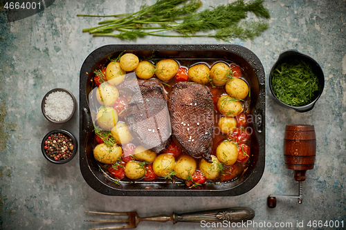 Image of Delicious roasted goose breast served with vegetables, potatoes.
