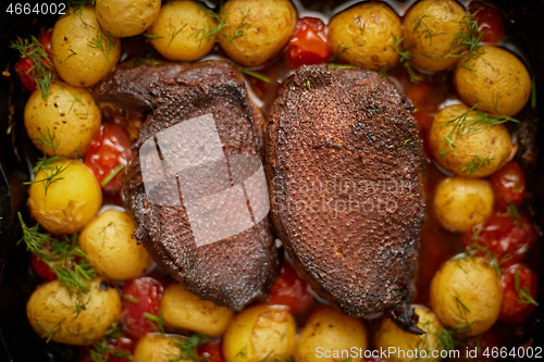 Image of Close up of Roasted Duck or Goose breast. Served with baked pota