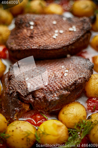 Image of Close up of Roasted Duck or Goose breast. Served with baked pota