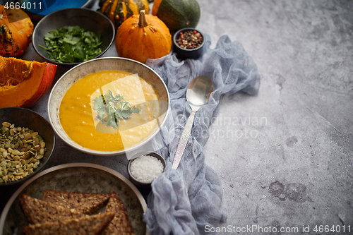 Image of Pumpkin soup decorated with parsley for Thanksgiving, halloween.