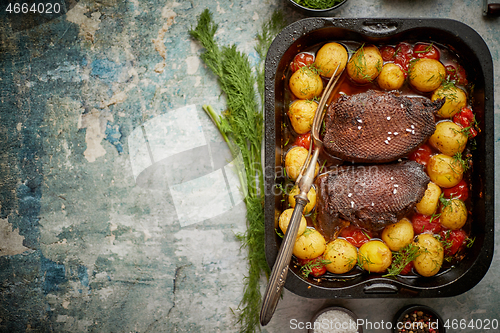 Image of Roasted duck breast with golden crispy skin served with baked po