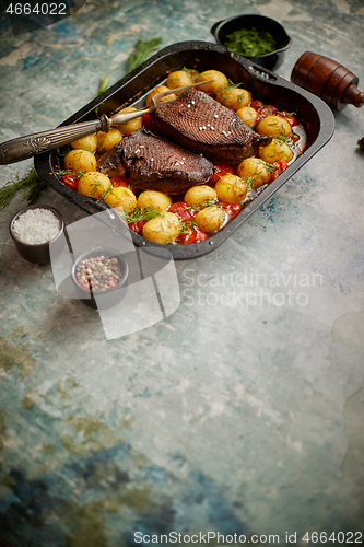 Image of Roasted duck breast with golden crispy skin served with baked potatoes, sprinkled with dill