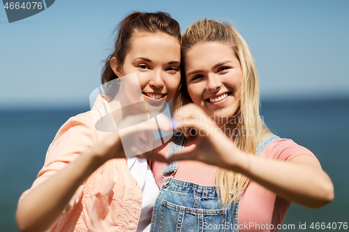 Image of teenage girls or best friends at seaside in summer