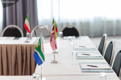 Image of table in boardroom at international conference