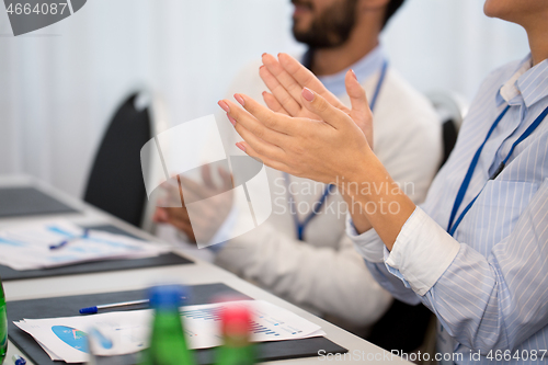 Image of happy people applauding at business conference