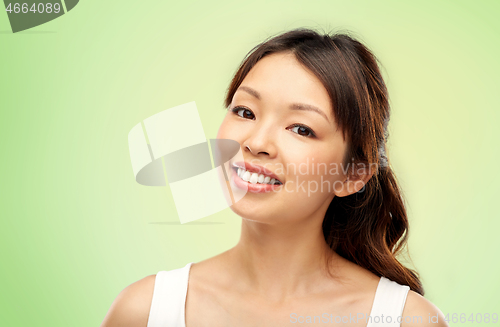 Image of face of happy smiling young asian woman