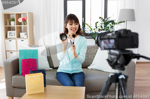 Image of female beauty blogger making video about make up