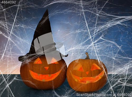 Image of two pumpkins or jack o lanterns and spiderweb