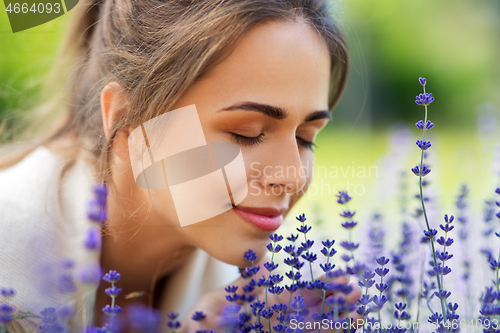 Image of close up of woman smelling lavender flowers