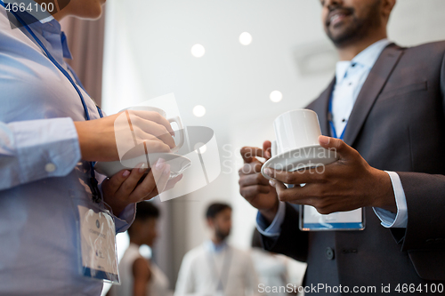 Image of business people with conference badges and coffee