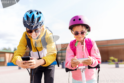 Image of school children with smartphones and scooters