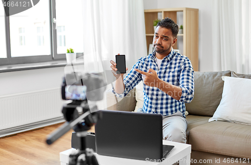 Image of male blogger with smartphone videoblogging