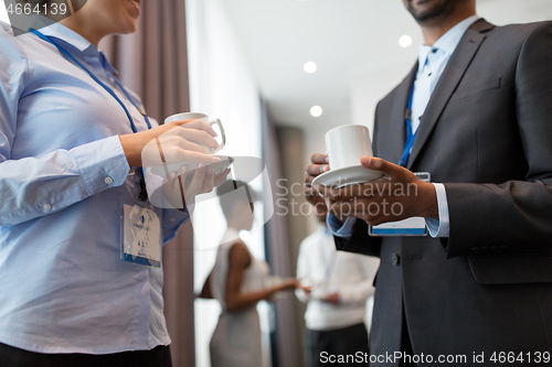 Image of business people with conference badges and coffee