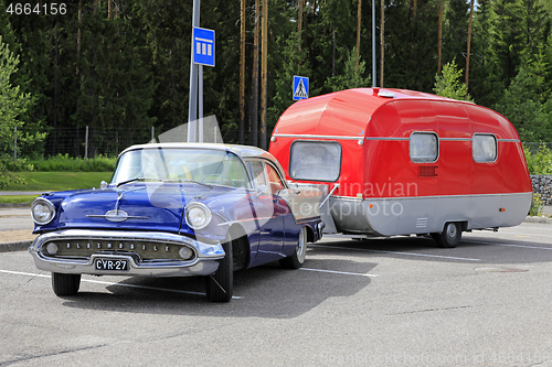 Image of Classic Oldsmobile Super 88 Pulling Camper Trailer