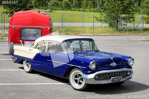 Image of Classic Oldsmobile Super 88 Pulling Camper Trailer