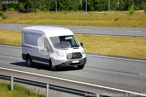 Image of White Ford Transit Van Delivers Goods