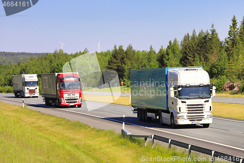 Image of Semi Trailer Trucks Deliver Goods on Freeway