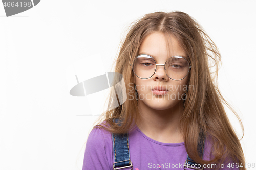 Image of Portrait of a funny girl with her long hair and half-closed eyes