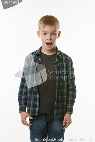 Image of Astonished ten year old boy with open mouth on white background