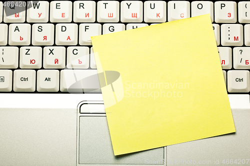 Image of Clear Yellow Sticky Note On Laptop Keyboard