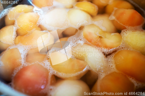 Image of peeled boiled apples in a sugar syrup