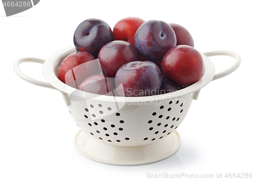 Image of fresh ripe plums in white colander