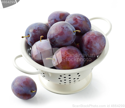 Image of fresh ripe plums in colander